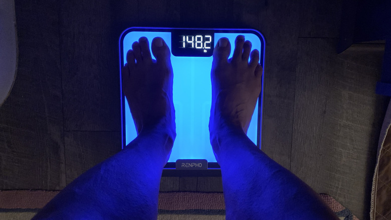 feet on a lighted scale in the dark