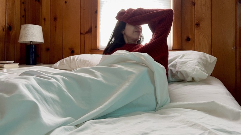 Woman waking up in bed