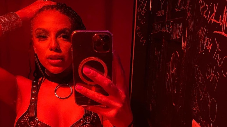 Mirror selfie of WeezyWTF wearing lingerie with a red filter