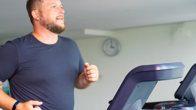 male in blue shirt on treadmill