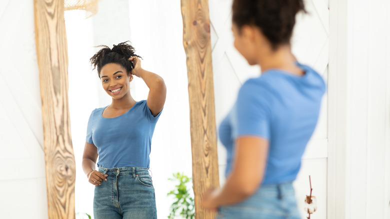 woman happy while looking in the mirror