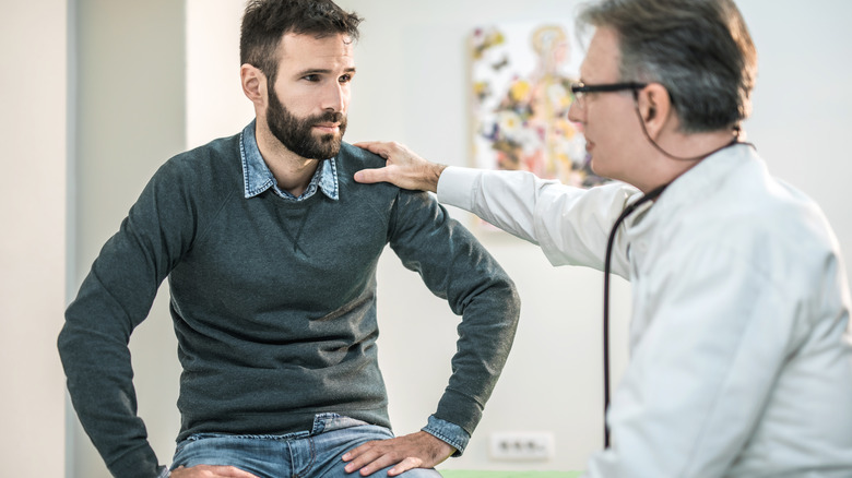 doctor calming nervous patient