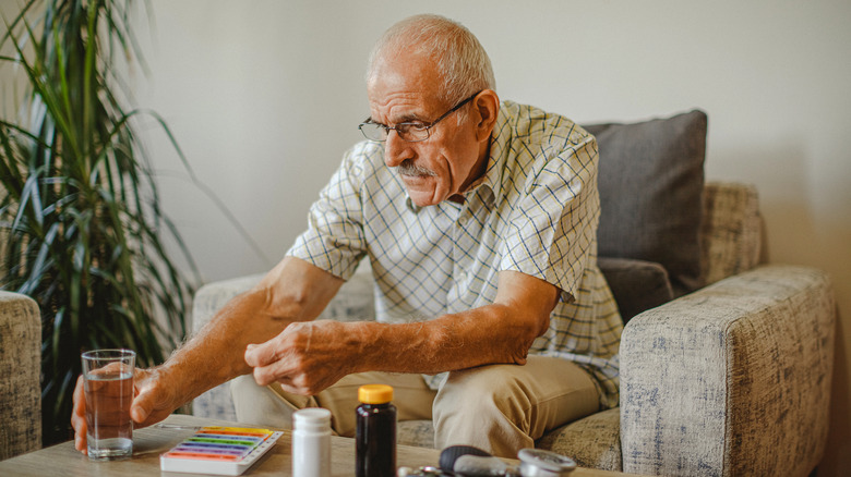 Mature man taking vitamins