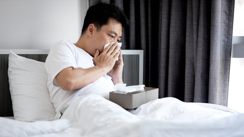 Man in bed with stuffy nose