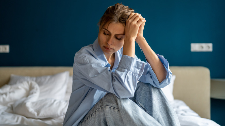 Woman looking worried in bed