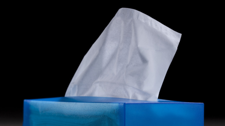 A box of tissues against a black background