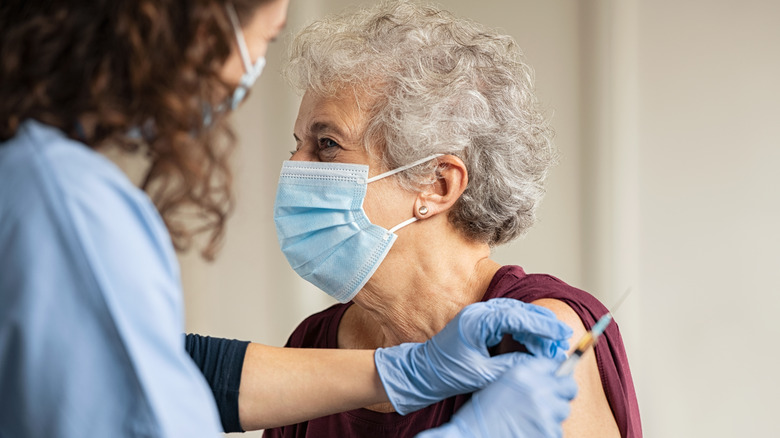 An older woman about to get vaccinated