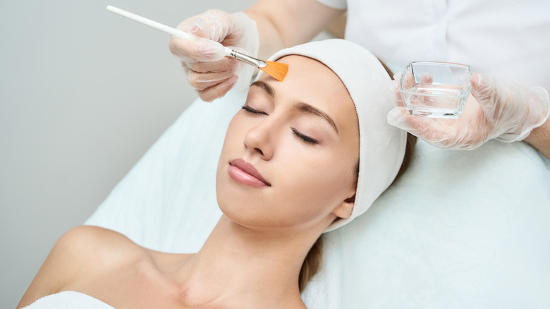 woman having a facial chemical peel done