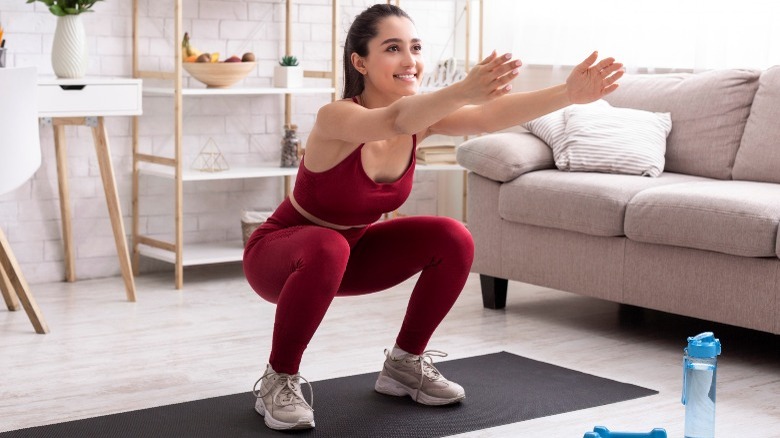 woman performing squat pose