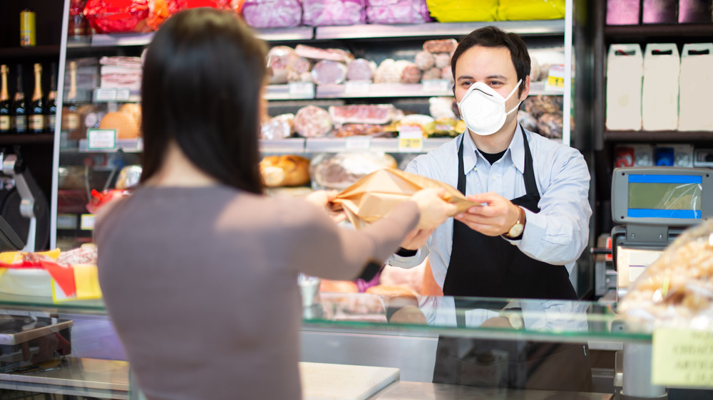 Grocery store worker wearing face mask