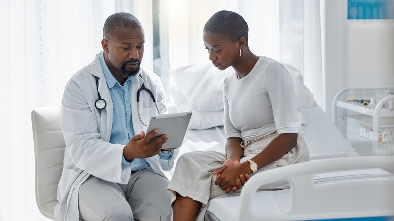 woman talking with her doctor about precancer treatments