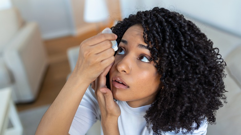 woman applying eye drops