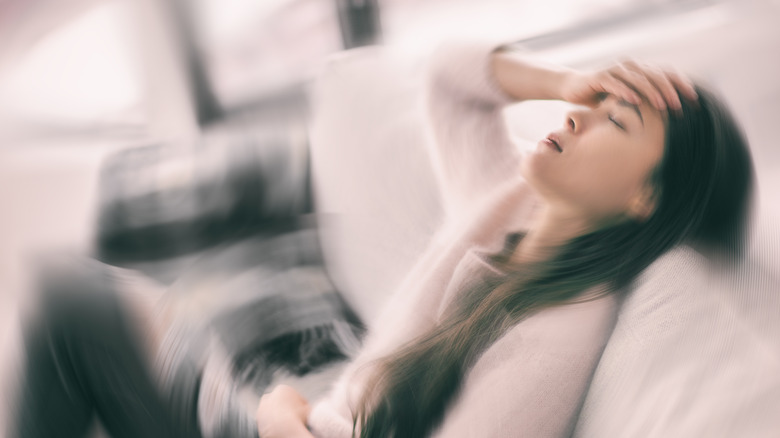 woman holding head in pain 