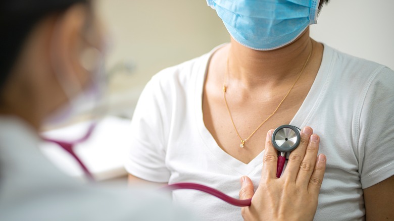 doctor checking patient