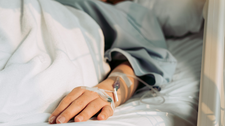 Woman's hand in hospital bed