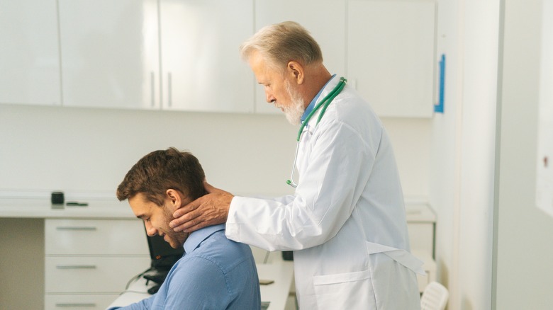 Doctor examining head closely