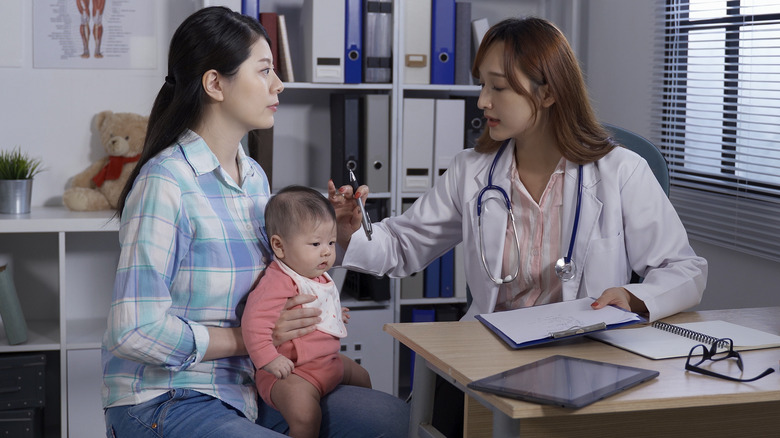 Doctor checking baby's head