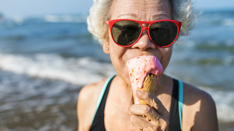 Elderly woman eating ice cream