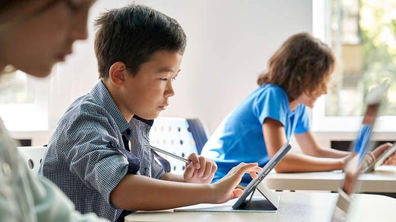 Adolescent boys sitting at desks