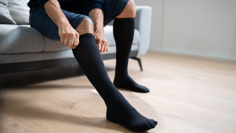 Person putting on compression stockings 