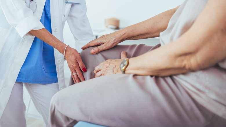 Doctor examining patient's knee