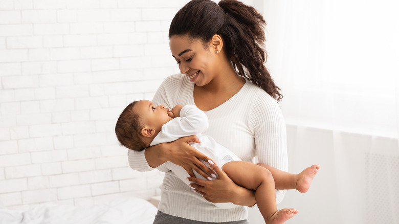 smiling mother holding newborn