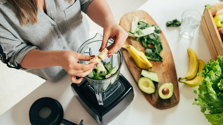 Woman preparing healthy smoothie