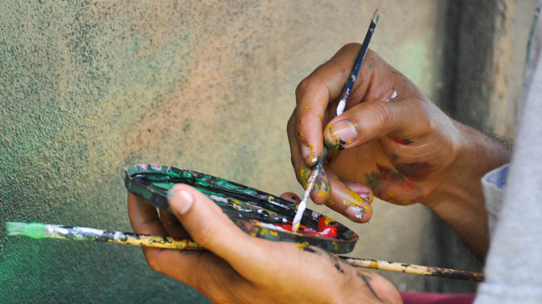 Person mixing paints