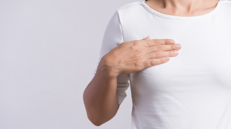 Woman performing breast self exam