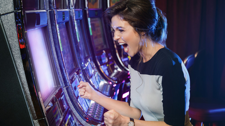 excited woman playing slot machines