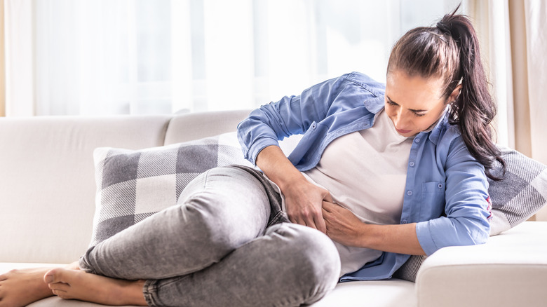 Woman holding stomach