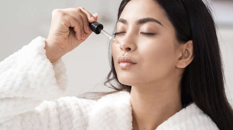 Woman applying essential oil to her nose