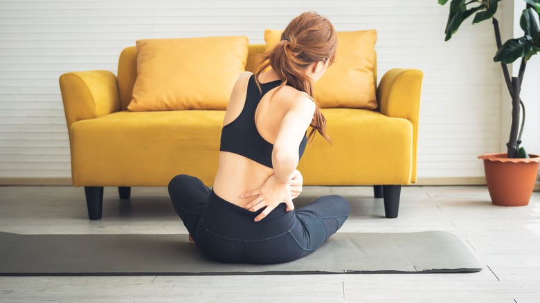 woman does gentle back stretch 