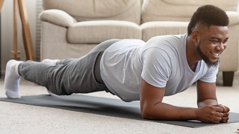 man does planks on floor