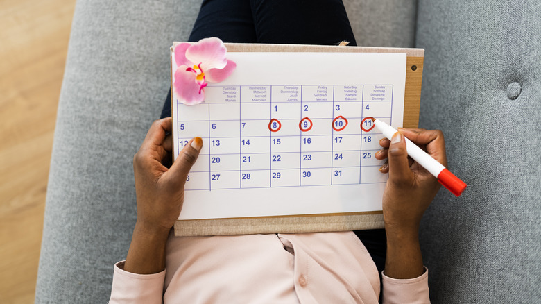 Woman using menstrual cycle calendar