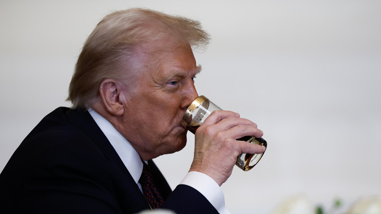 Donald Trump in 2025 drinking from a glass