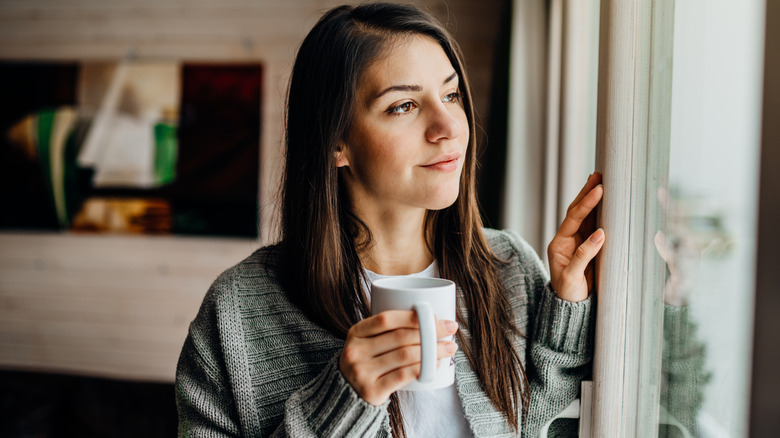 woman holding cup of tea