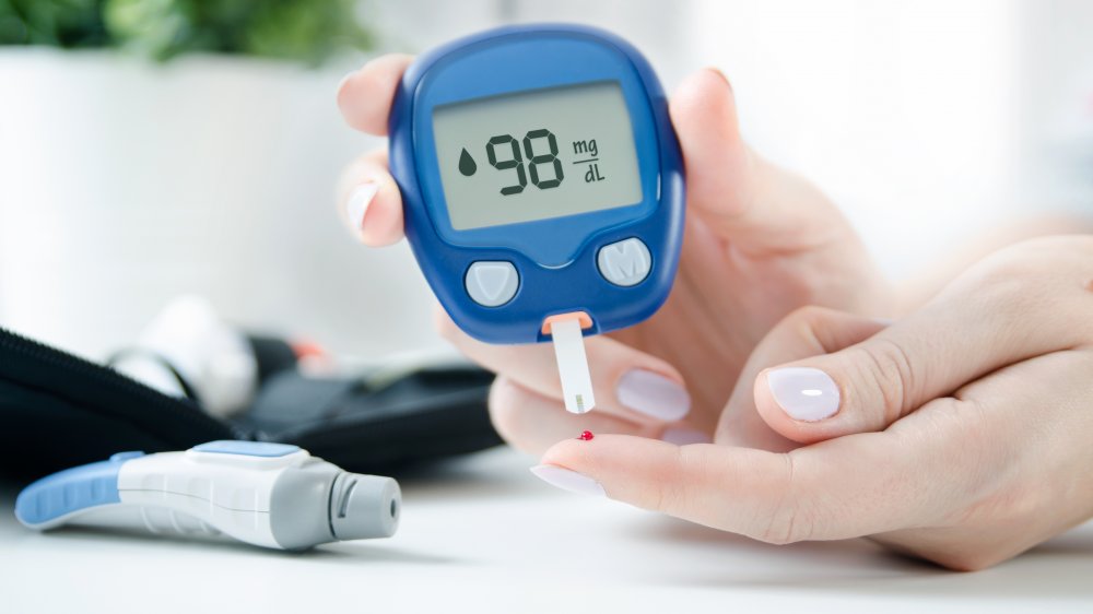 woman testing blood sugar