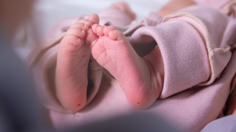 Newborn's feet with heel pricks