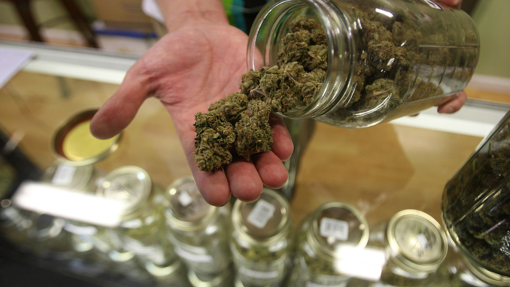 hand holding marijuana in dispensary 