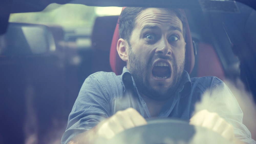 man screaming in car