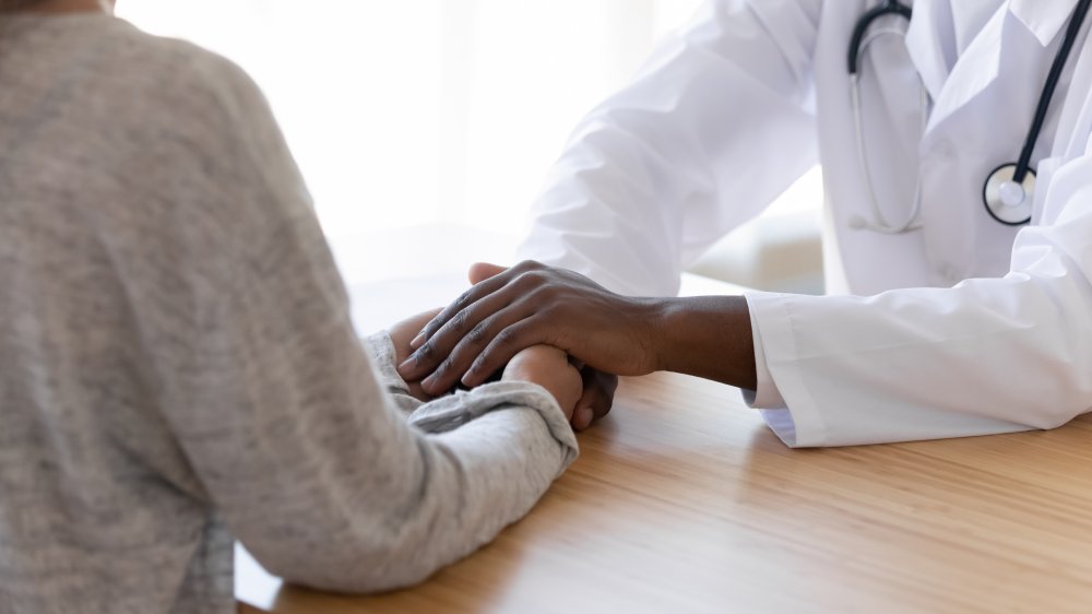 Doctor comforting patient