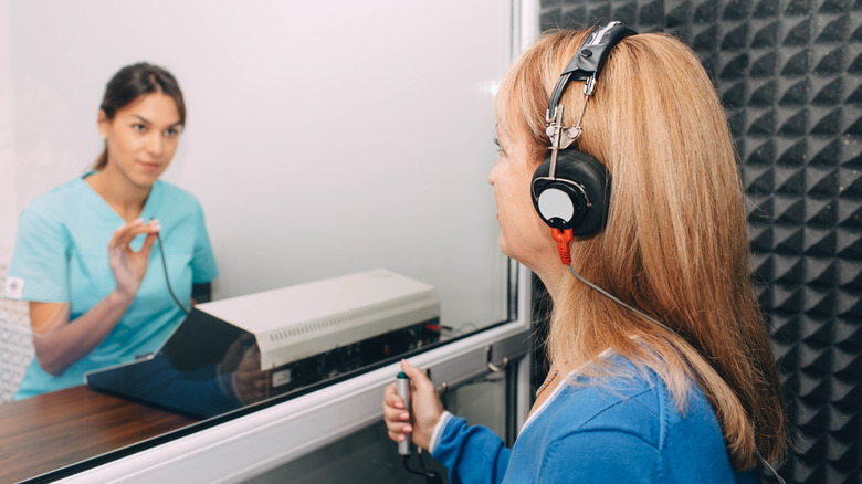 Woman undergoing hearing exam in headphones