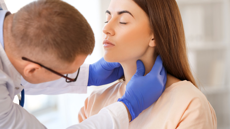 Person being checked for hyperthyroidism
