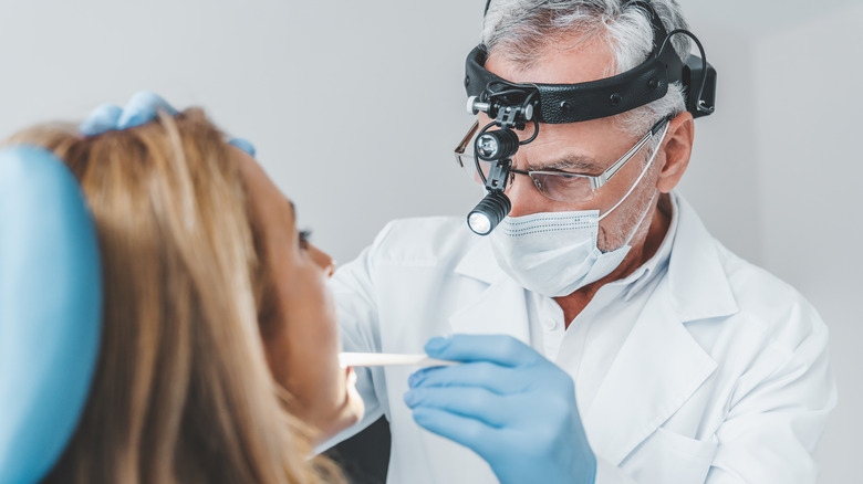 doctor testing a woman for strep throat 