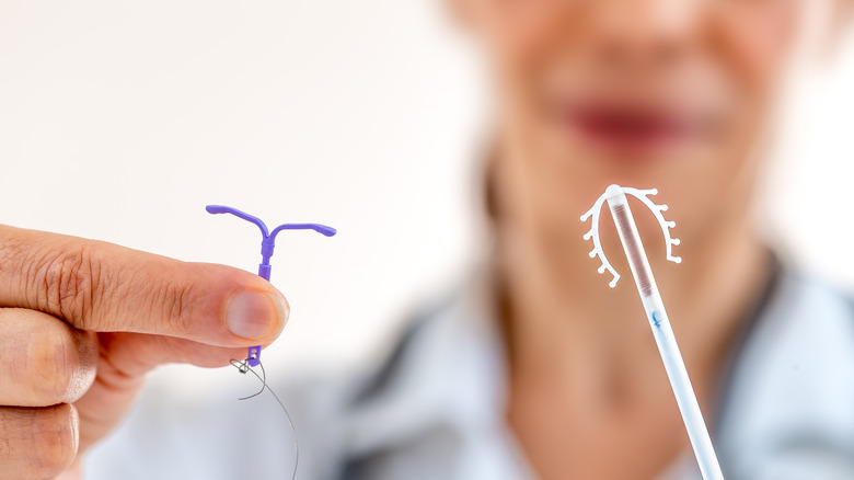 Doctor holding IUD