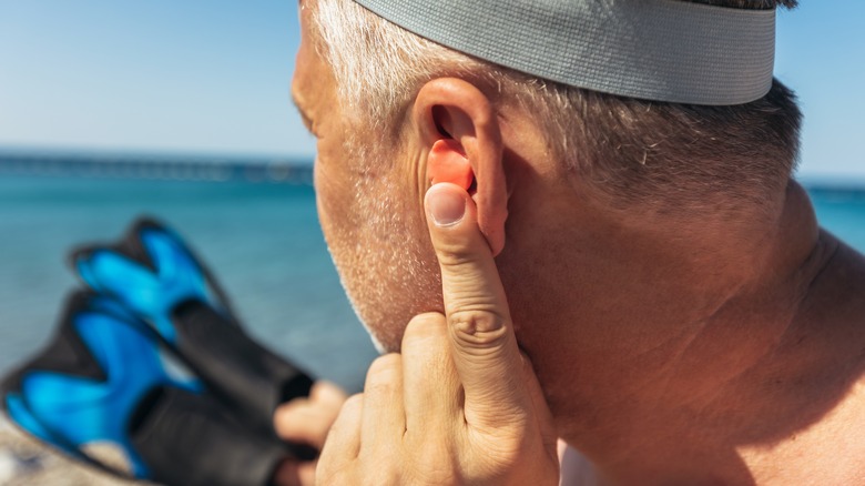 Swimmer with ear plugs