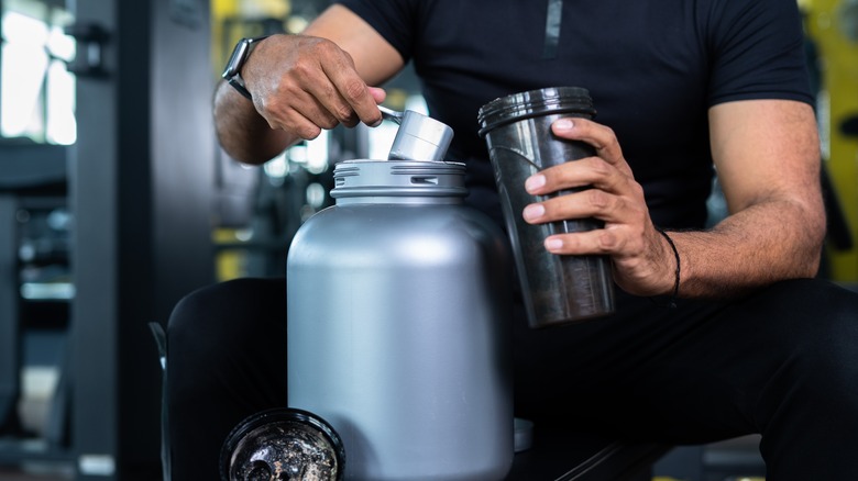 Man scooping protein powder