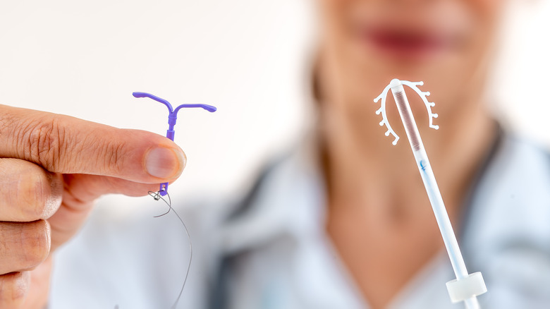 Female doctor holding IUDs