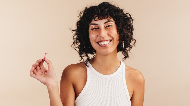 Woman holding IUD